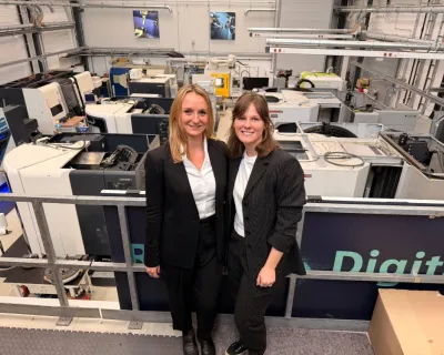 two founders of factory maker with the interior of factory behind them